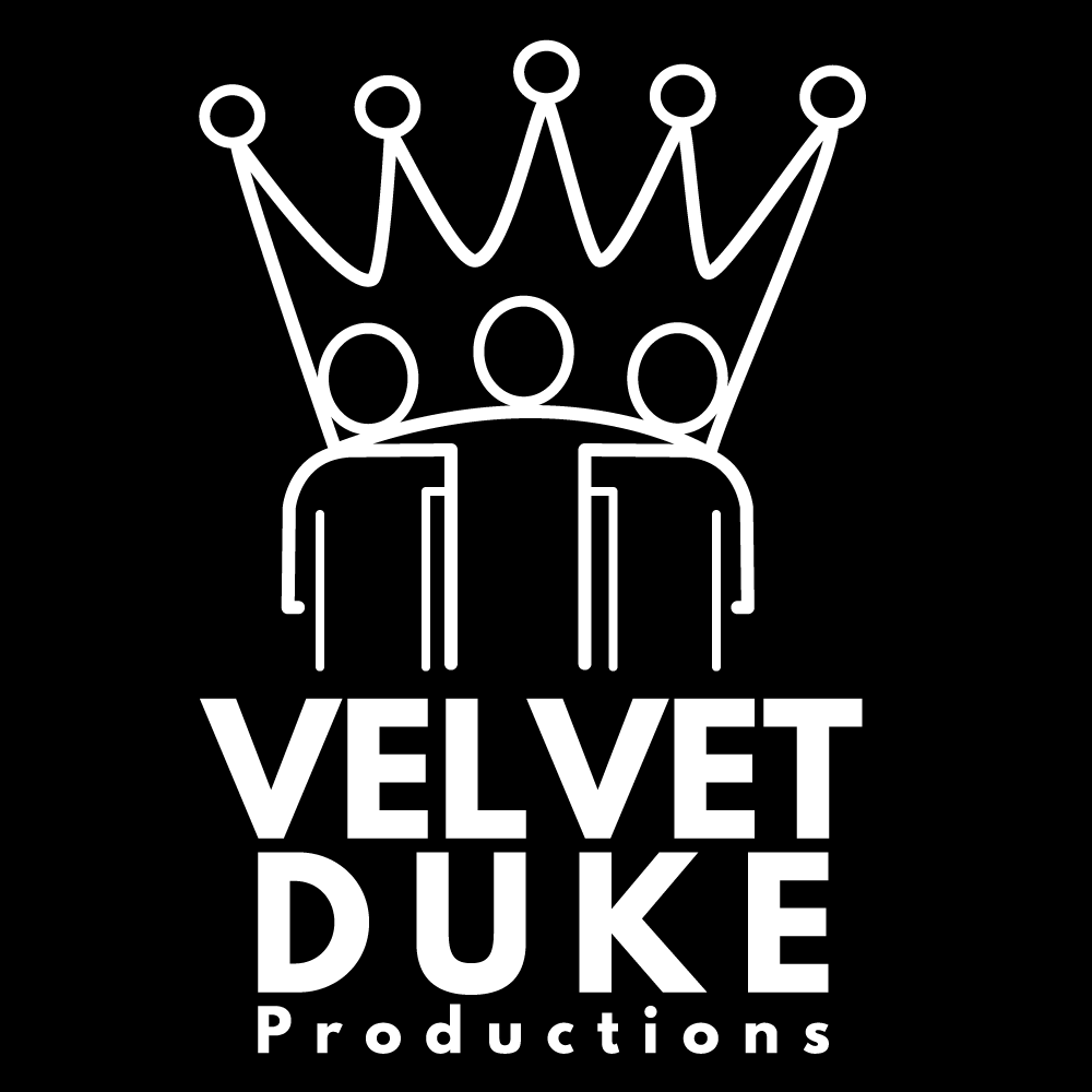 Image Description: The Velvet Duke Productions logo and watermark is a white line drawing of a crown resting on the shoulders of three performers, incorporating their heads as bigger jewels. Below the logo are the words Velvet Duke Productions. All centered on a black background. The crown and performers represent the "I is We" nature of community, and creative energy within the world