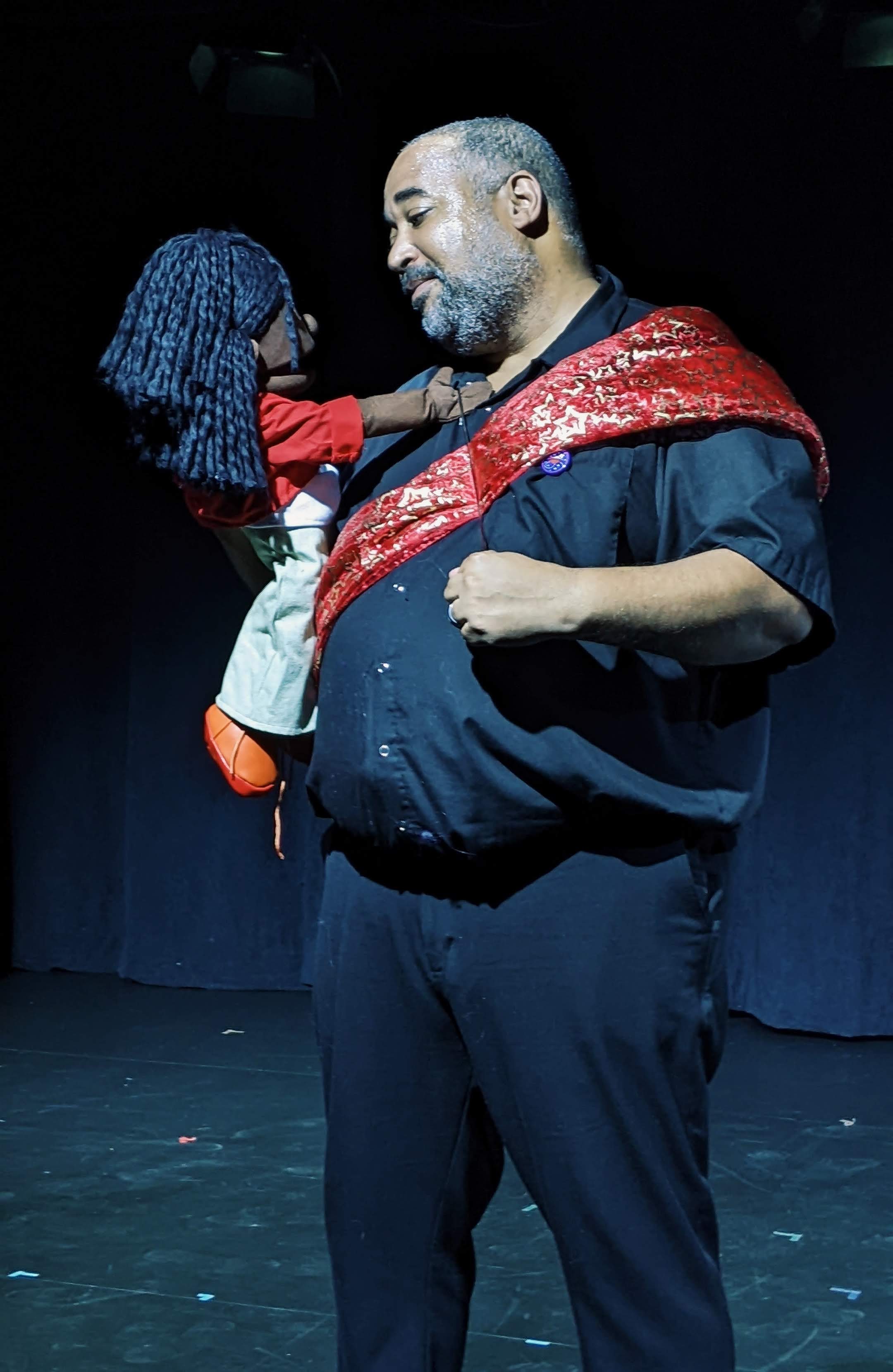 Photo from Ottawa Fringe Festival production of (Re)Tired Magical Black Man. Asase (Black female puppet) and dJerald (nonbinary Djinn) face each other, sharing platonic love. photo: Anna M