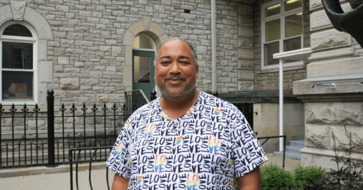 Velvet Wells smiles and stands outside the Arts Court on Oct. 23, 2024. They conducted the “Practicing Disruption” workshop at the Grove on Oct. 19 and Nov. 9 which uses improv to disrupt racism in people's day-to-day lives. [Photo by Ana Maria Cadena/ The Charlatan]
